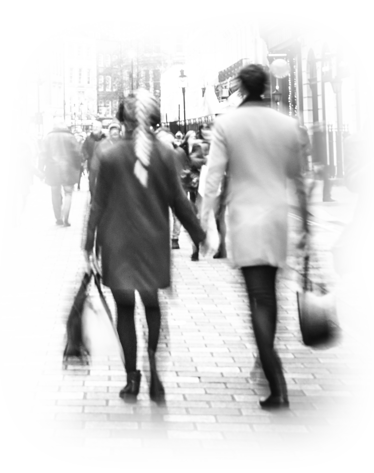 Male and Female holding hands with their bags walking down the street
